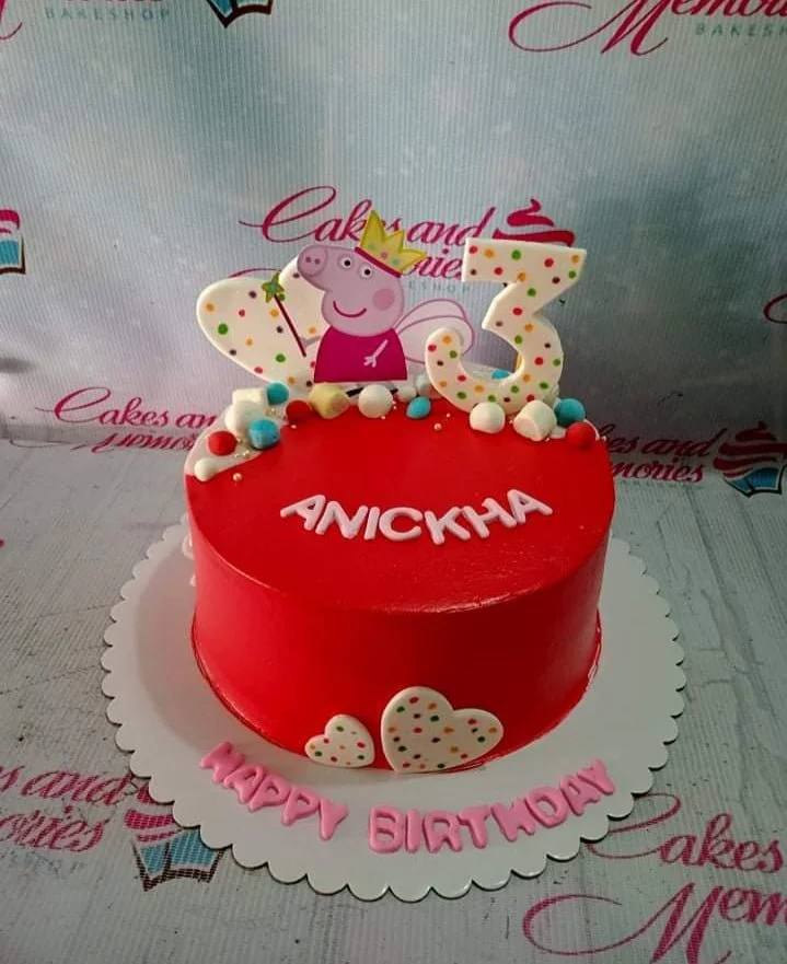 Red Peppa Pig birthday cake with a large number 3 topper, marshmallows, and heart decorations.