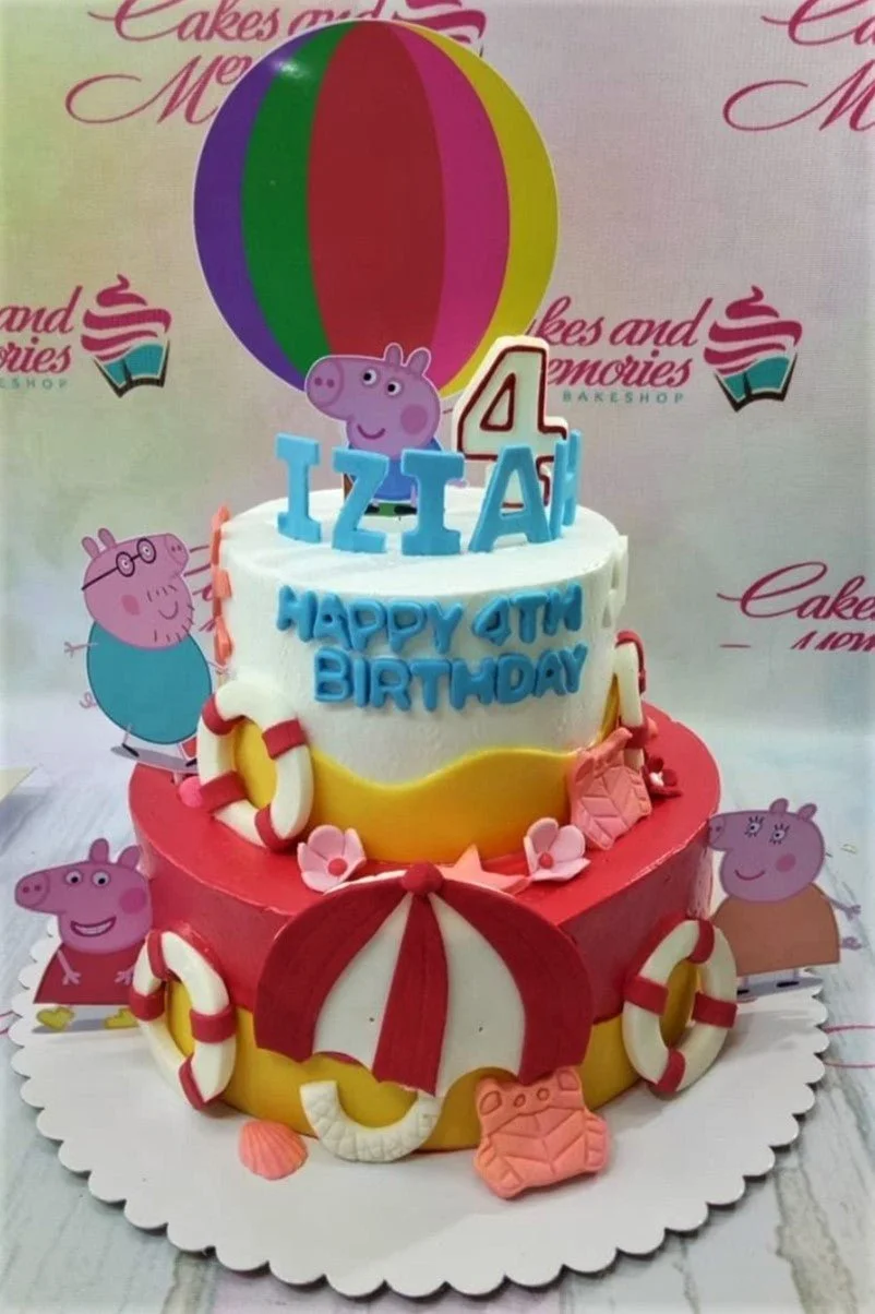 Two-tier Peppa Pig themed birthday cake with a colorful hot air balloon topper, red and yellow icing, and fondant lifebuoys.