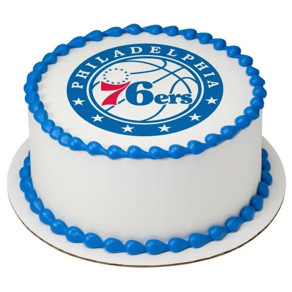 Philadelphia 76ers White Cake A white and blue round 1-tier cake themed around Philadelphia 76ers, featuring a basketball logo printout and blue icing borders.