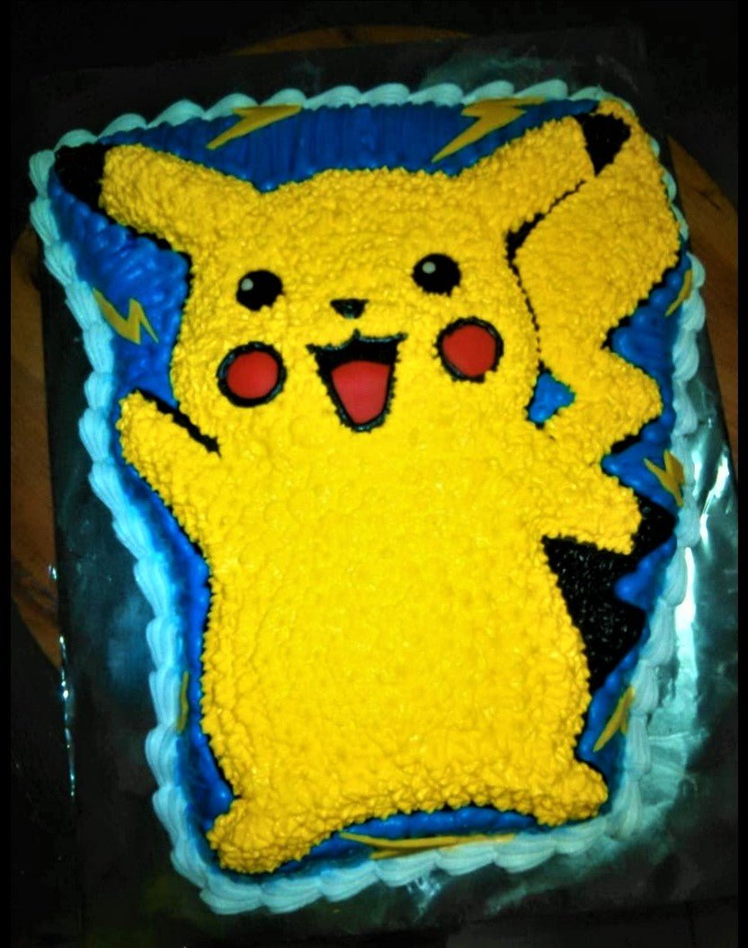 Pikachu character cake with yellow star-piped icing, blue background, and white ruffled border. Pikachu character cake with yellow star-piped icing, blue background, and white ruffled border.