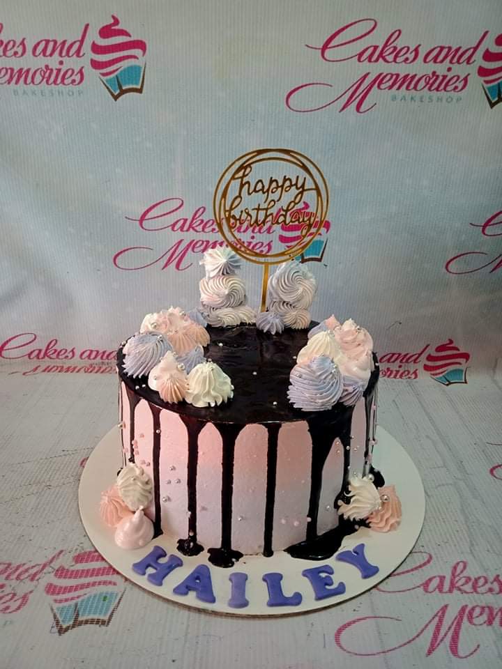 Pink and purple gradient cake with chocolate drip, colorful icing swirls, silver dragees, and a gold Happy Birthday topper. Pink and purple gradient cake with chocolate drip, colorful icing swirls, silver dragees, and a gold Happy Birthday topper.