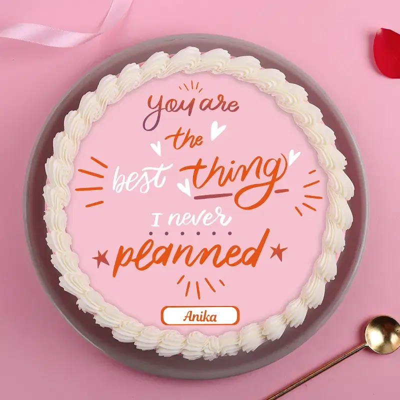 Pink bento cake with white piped icing border and a printed message 'You are the best thing I never planned' for Anika. Pink bento cake with white piped icing border and a printed message 'You are the best thing I never planned' for Anika.