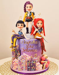 Purple gradient cake with three pop star figurines, city skyline panels, and musical notes Purple gradient cake with three pop star figurines, city skyline panels, and musical notes
