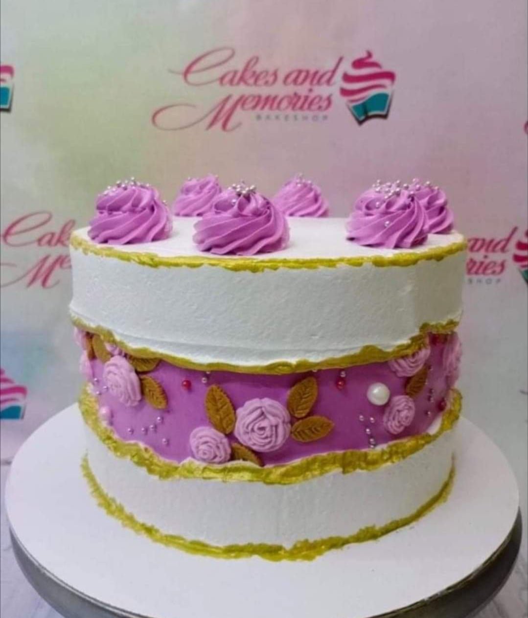 White and purple fault line cake with gold edges, purple icing rosettes, and silver dragees. White and purple fault line cake with gold edges, purple icing rosettes, and silver dragees.