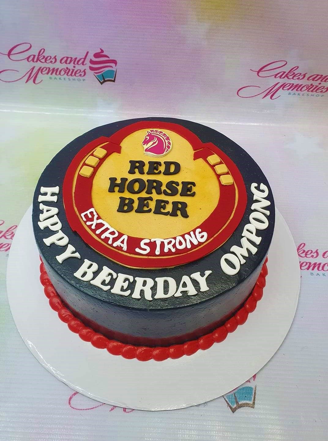 Red Horse Beer themed birthday cake with black icing, red border, and a large beer logo topper. Red Horse Beer themed birthday cake with black icing, red border, and a large beer logo topper.