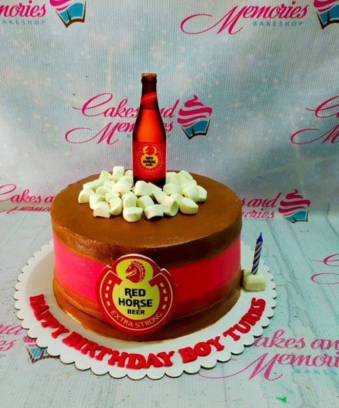 Red Horse Beer themed birthday cake with a beer bottle topper, marshmallows, and a red logo on brown icing. Red Horse Beer themed birthday cake with a beer bottle topper, marshmallows, and a red logo on brown icing.
