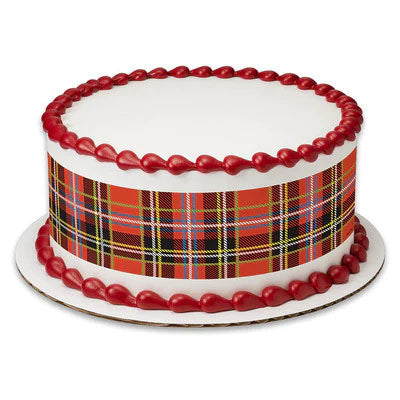 White round cake with a red and yellow plaid tartan pattern wrap and red icing teardrop borders on top and bottom. White round cake with a red and yellow plaid tartan pattern wrap and red icing teardrop borders on top and bottom.