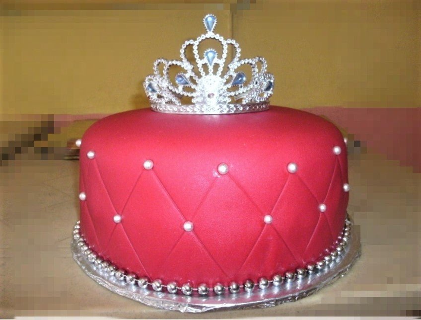 Red fondant cake with quilted diamond pattern, silver pearls, and a silver rhinestone tiara topper. Red fondant cake with quilted diamond pattern, silver pearls, and a silver rhinestone tiara topper.