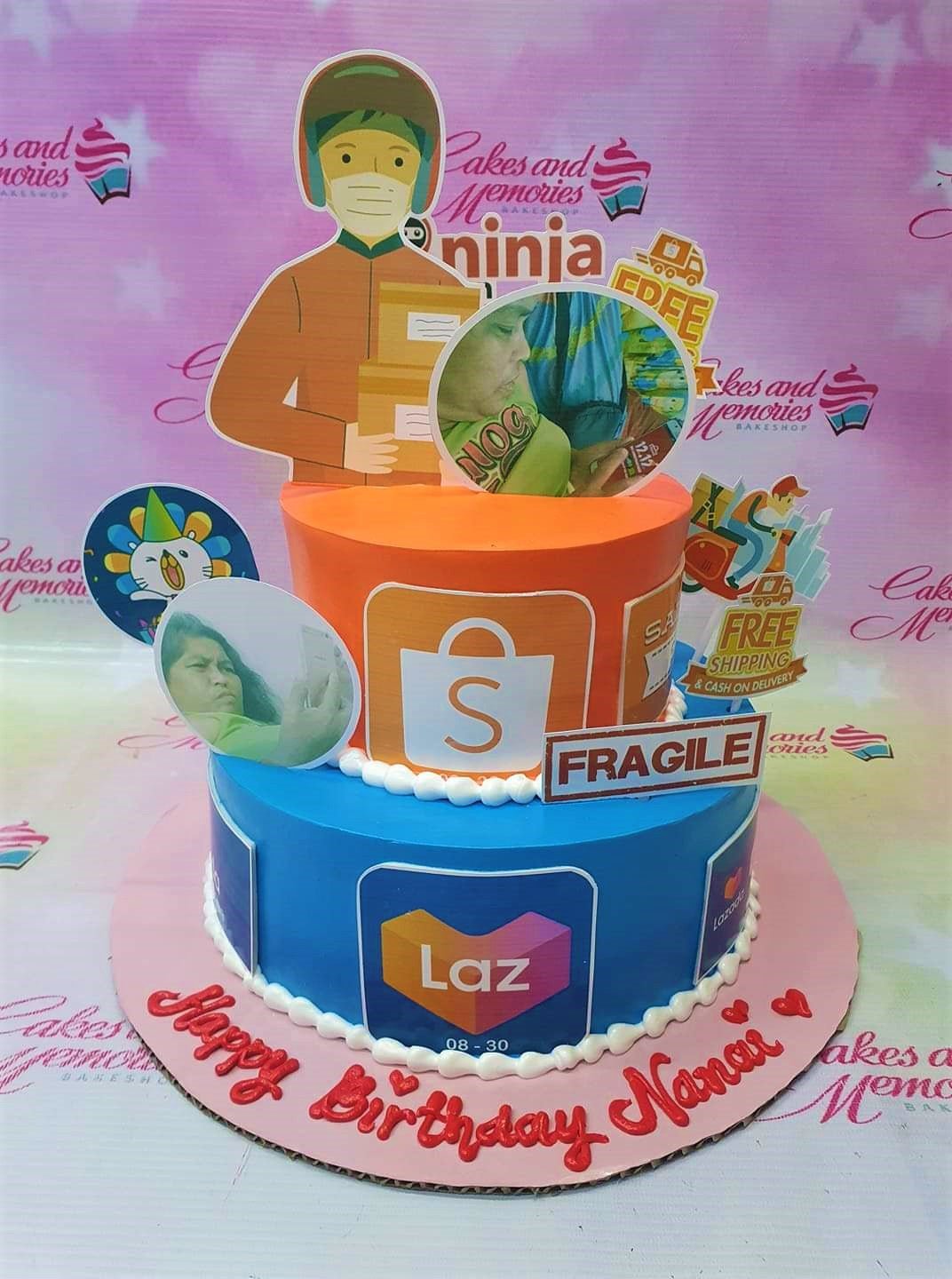Two-tier orange and blue delivery themed cake with Shopee and Lazada logos, delivery rider printouts, and personal photos. Two-tier orange and blue delivery themed cake with Shopee and Lazada logos, delivery rider printouts, and personal photos.
