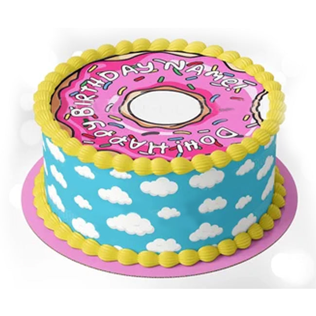 Simpsons themed donut cake with pink icing, sprinkles, and a blue cloud sky side design with yellow piped borders. Simpsons themed donut cake with pink icing, sprinkles, and a blue cloud sky side design with yellow piped borders.