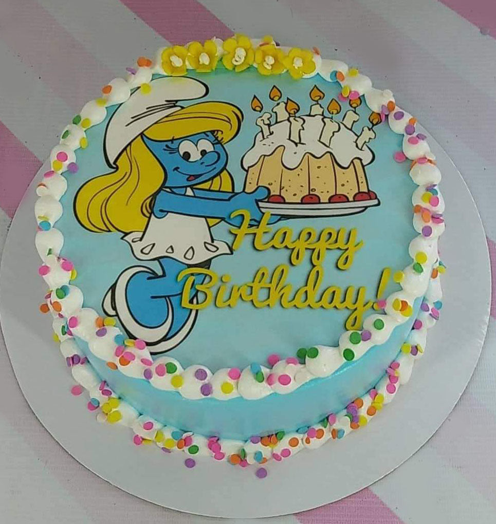 Light blue Smurfette birthday cake with white icing borders and colorful sprinkles Light blue Smurfette birthday cake with white icing borders and colorful sprinkles
