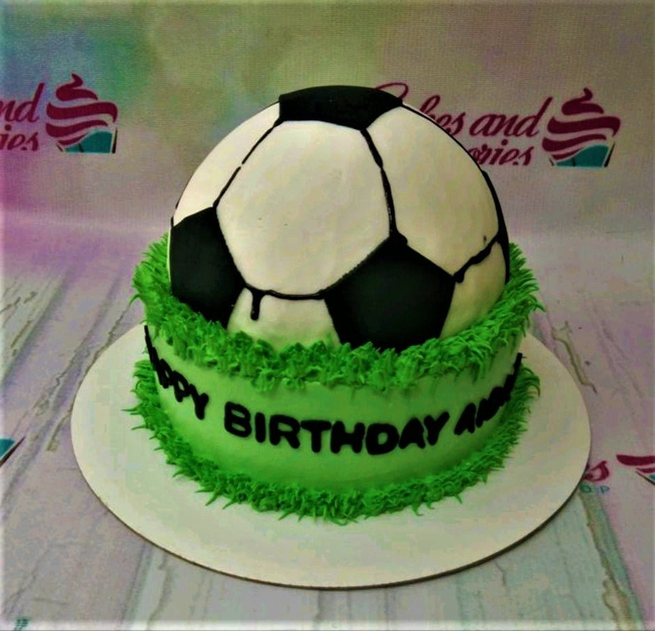 Soccer ball shaped cake on a green grass-textured base with a Happy Birthday message. Soccer ball shaped cake on a green grass-textured base with a Happy Birthday message.