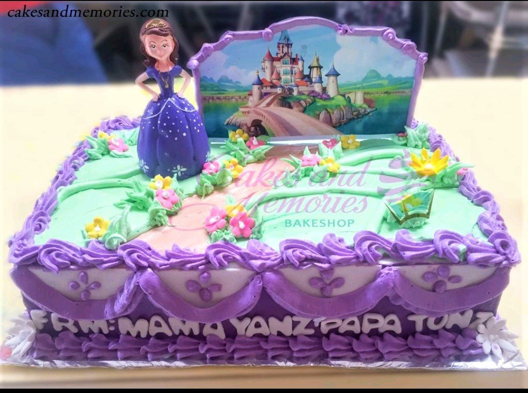 Sofia the First themed rectangle cake with a castle printout, Sofia figurine, and purple icing borders with pink and yellow flowers. Sofia the First themed rectangle cake with a castle printout, Sofia figurine, and purple icing borders with pink and yellow flowers.