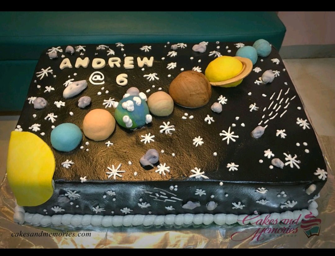 Space themed rectangle cake with black icing, fondant planets, and white icing stars for a 6th birthday. Space themed rectangle cake with black icing, fondant planets, and white icing stars for a 6th birthday.