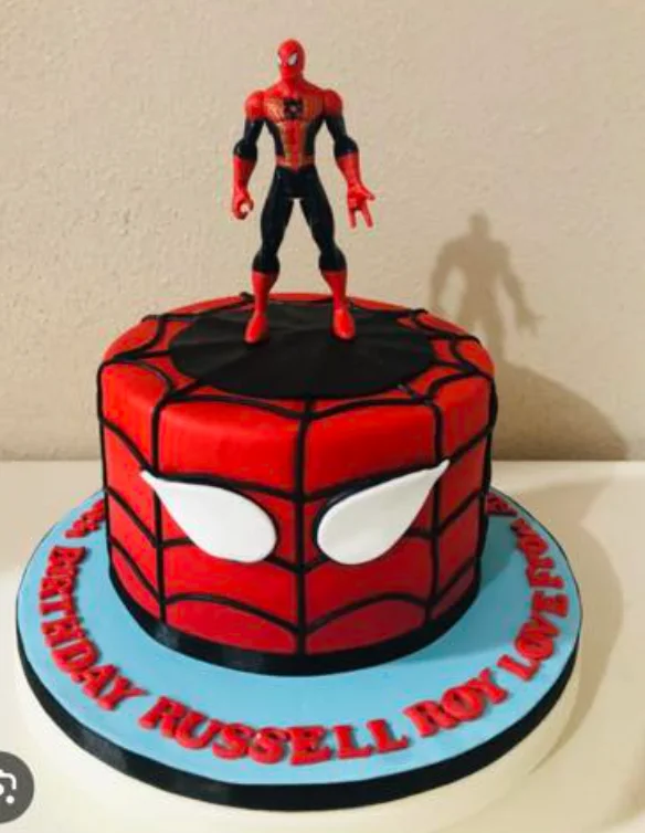 A red 1 Tier cake featuring a Spiderman action figure, a black spider web panel, and a gumpaste birthday message.