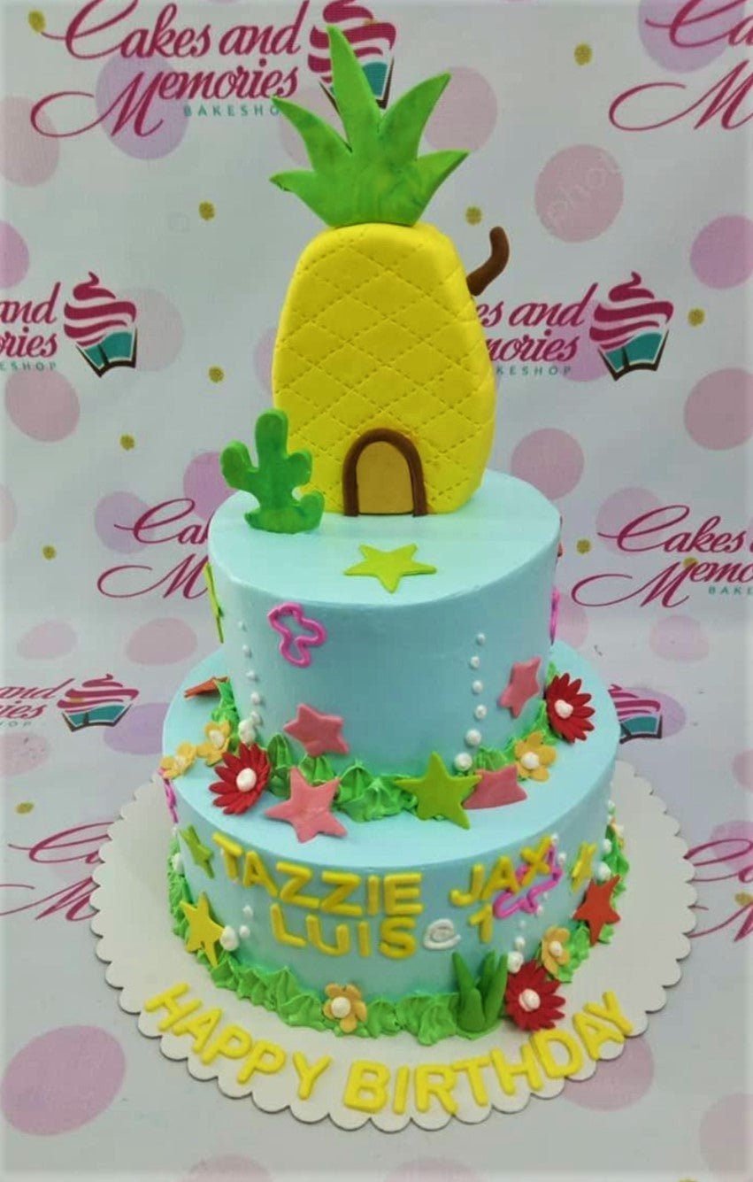 Two-tier light blue SpongeBob SquarePants themed cake with a large yellow pineapple house topper and colorful underwater decorations. Two-tier light blue SpongeBob SquarePants themed cake with a large yellow pineapple house topper and colorful underwater decorations.