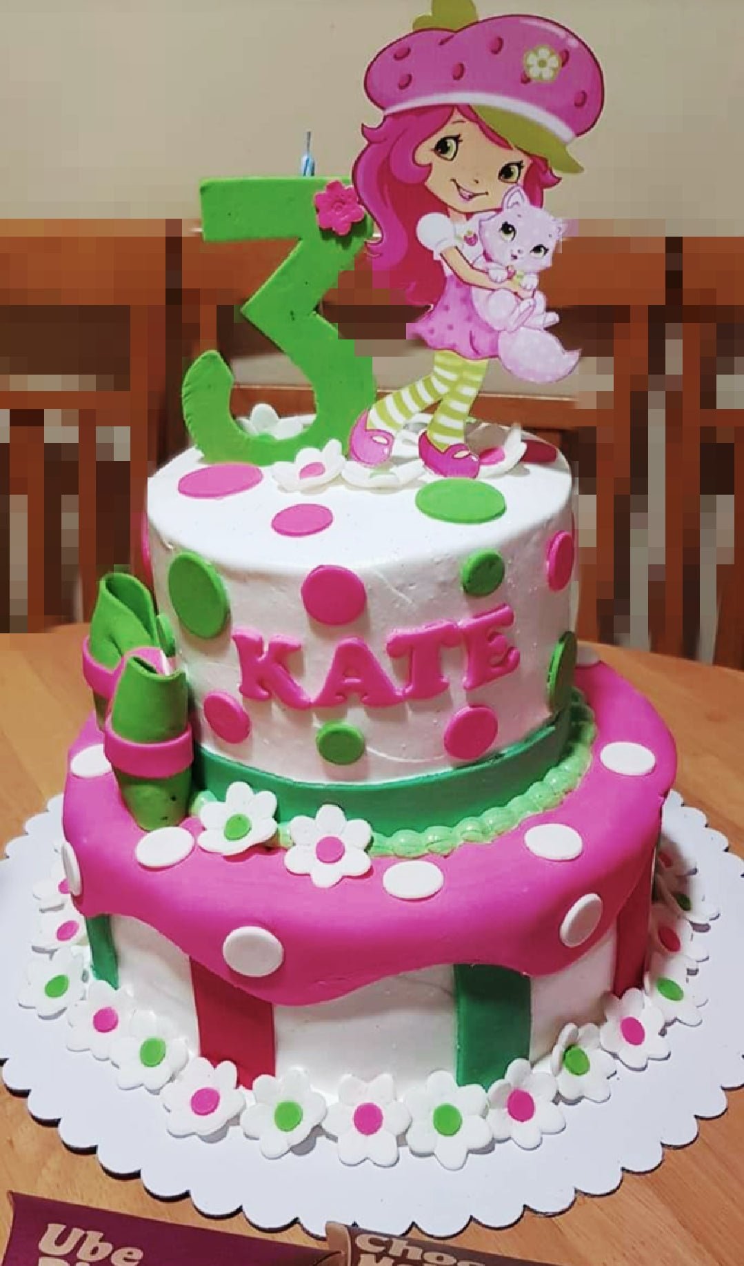 Strawberry Shortcake Cake - 2202 Two-tier Strawberry Shortcake themed birthday cake with pink and green polka dots, fondant flowers, and a character printout topper.