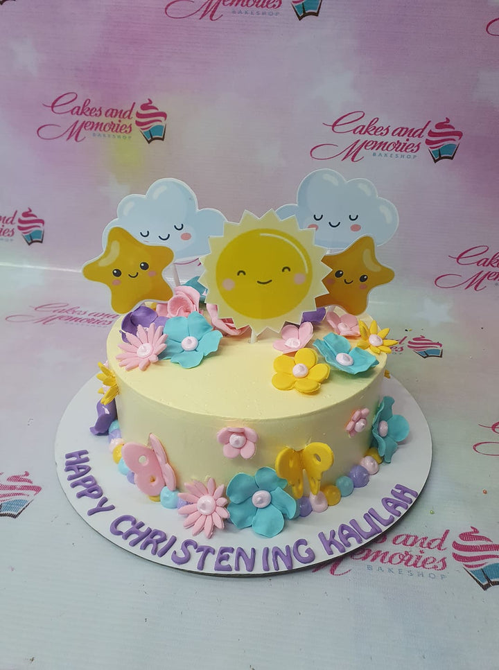 Yellow christening cake with sun, stars, and clouds printout toppers, decorated with colorful fondant flowers and butterflies. Yellow christening cake with sun, stars, and clouds printout toppers, decorated with colorful fondant flowers and butterflies.
