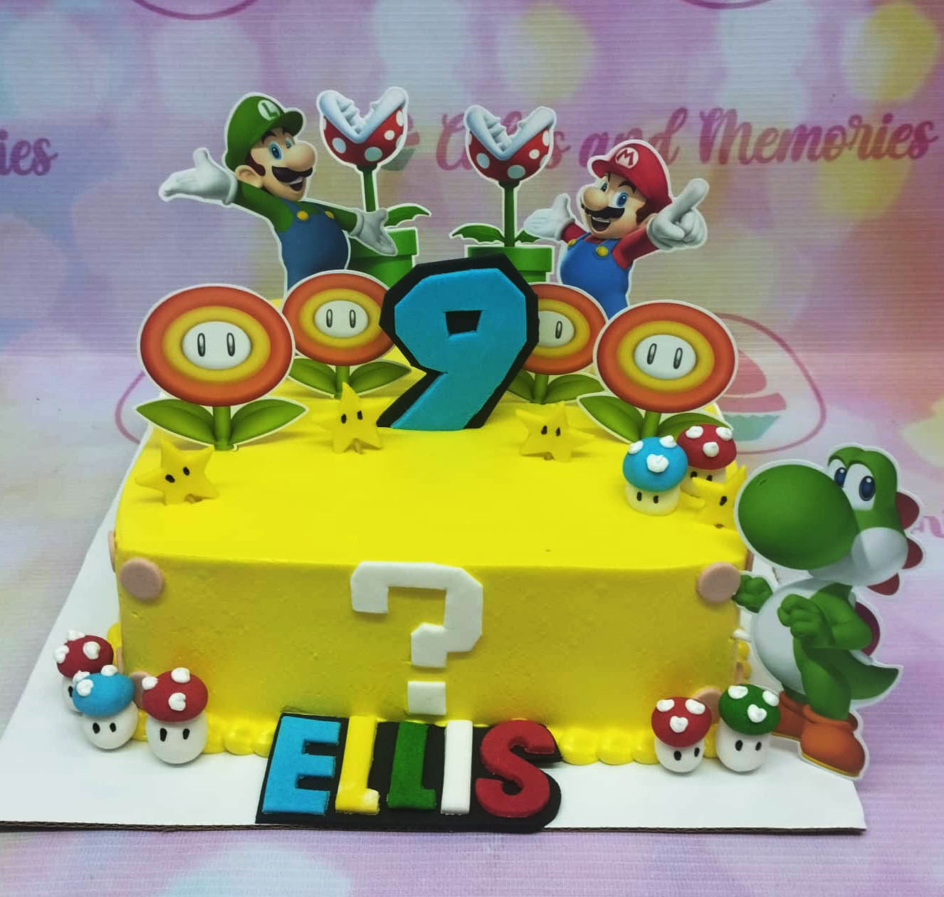 Yellow square Super Mario themed birthday cake with Mario, Luigi, Yoshi, and Piranha Plant toppers and fondant mushrooms. Yellow square Super Mario themed birthday cake with Mario, Luigi, Yoshi, and Piranha Plant toppers and fondant mushrooms.