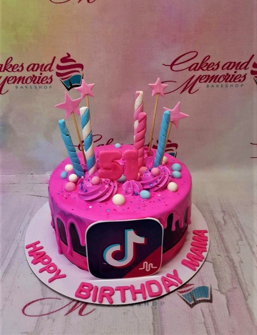 Hot pink TikTok themed birthday cake with a large logo, pink and blue striped toppers, and pink number 51. Hot pink TikTok themed birthday cake with a large logo, pink and blue striped toppers, and pink number 51.