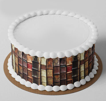 Round white cake with a vintage book spine edible print wrap and white icing shell borders. Round white cake with a vintage book spine edible print wrap and white icing shell borders.