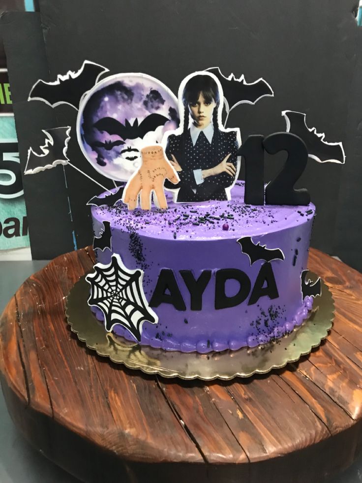 Purple Wednesday Addams themed birthday cake with black bats, spider web, and character toppers for Ayda's 12th birthday. Purple Wednesday Addams themed birthday cake with black bats, spider web, and character toppers for Ayda's 12th birthday.