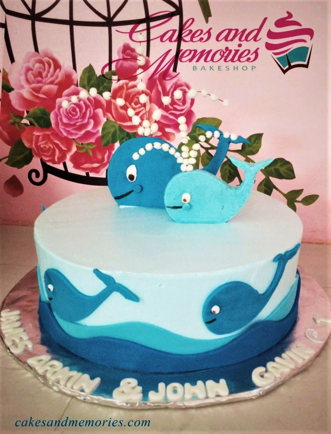 Whale Sky Blue Birthday Cake Light blue whale themed birthday cake with two blue fondant whale toppers and white bubble accents.