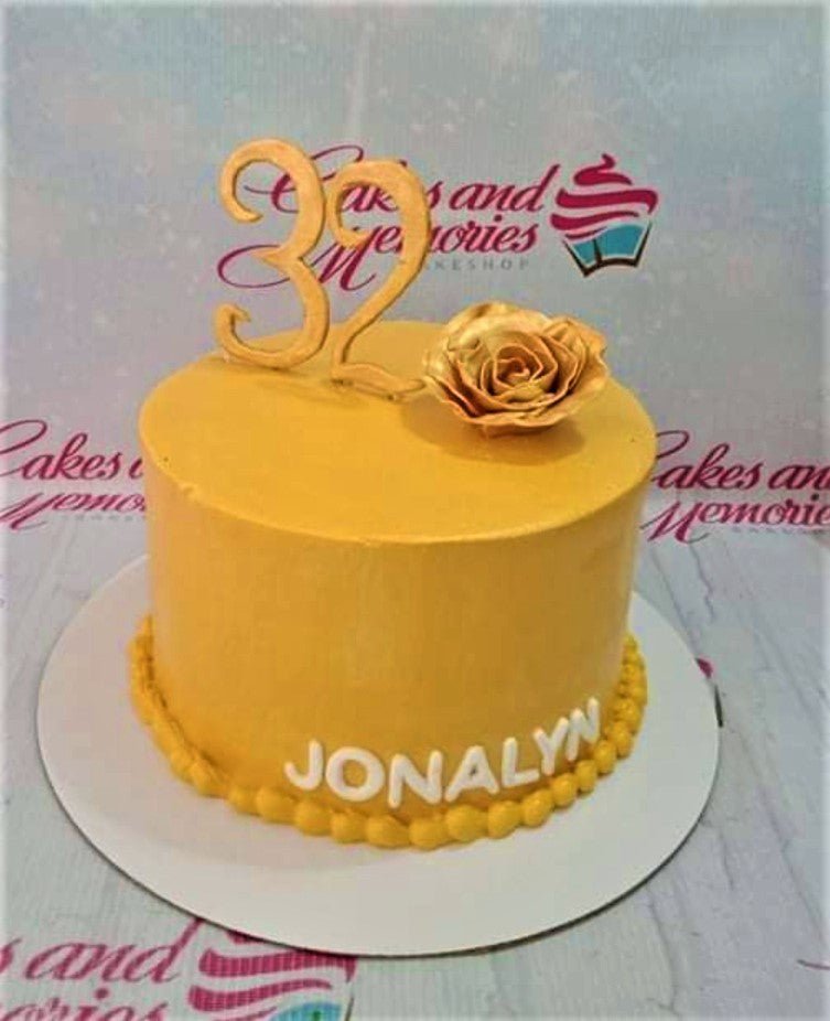 Yellow minimalist birthday cake with a gold rose and number 32 topper for Jonalyn. Yellow minimalist birthday cake with a gold rose and number 32 topper for Jonalyn.