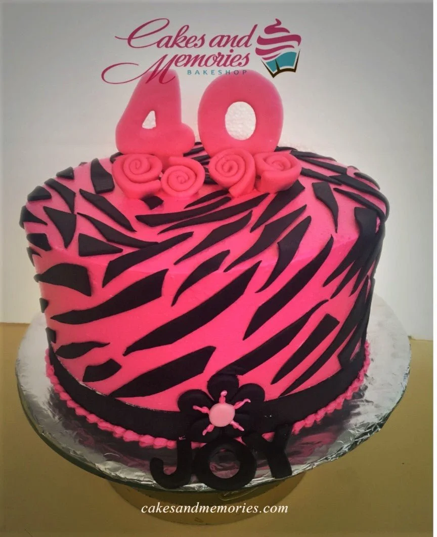 Zebra Print Floral Birthday Cake A pink and black 1-tier cake themed around Zebra Print, featuring large pink fondant number 40 and a black flower decoration.