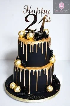 Two-tier black fondant cake with gold drips, Ferrero Rocher chocolates, and a gold Happy 21st Ryan topper.