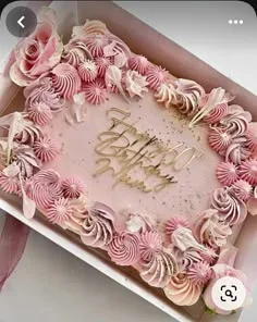 Pink rectangle birthday cake with elaborate pink and lavender icing rosettes and a gold Happy 60th Birthday Mum topper.