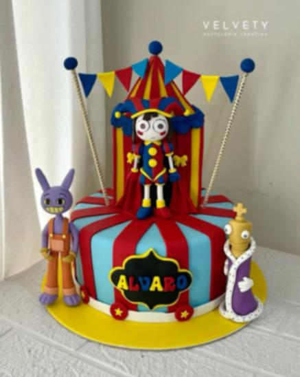 A vibrant circus-themed fondant cake featuring characters from The Amazing Digital Circus including Pomni, Jax, and Kinger with a red and blue striped design. A vibrant circus-themed fondant cake featuring characters from The Amazing Digital Circus including Pomni, Jax, and Kinger with a red and blue striped design.