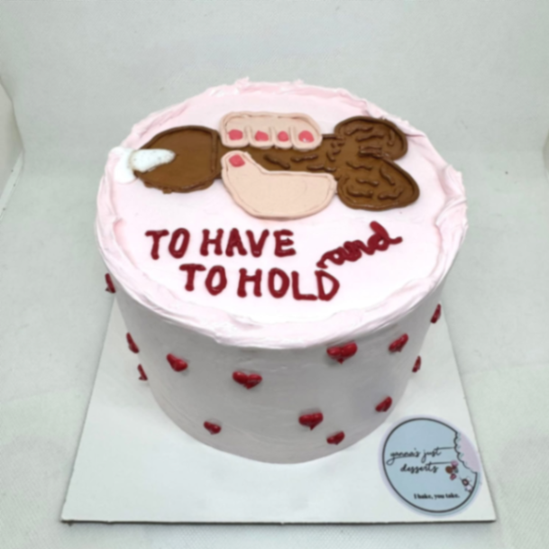 Light pink minimalist cake with a humorous brown hand-drawn illustration and red heart accents. Light pink minimalist cake with a humorous brown hand-drawn illustration and red heart accents.