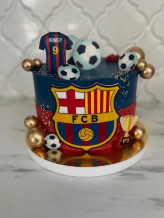 Barcelona Soccer Navy Cake Navy blue 1-tier soccer cake with smooth soft icing, an FC Barcelona jersey topper, and gold spheres