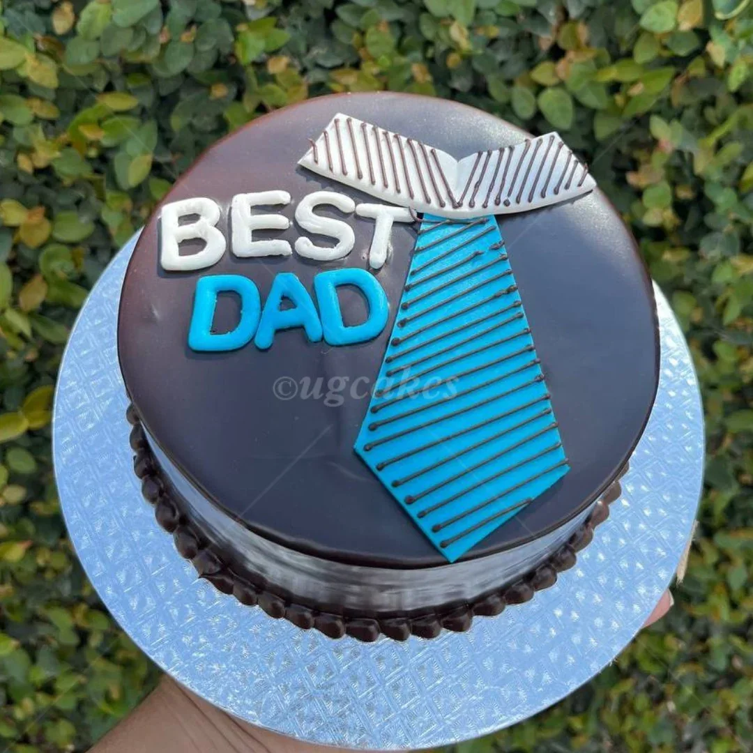 Chocolate cake for Father's Day with a blue and white fondant tie and 'BEST DAD' message. Chocolate cake for Father's Day with a blue and white fondant tie and 'BEST DAD' message.