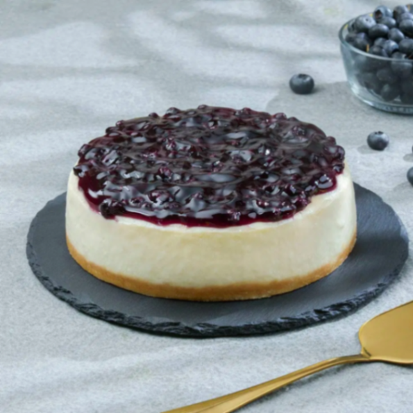 A classic round blueberry cheesecake with a thick graham cracker crust and a generous topping of glossy blueberry compote. A classic round blueberry cheesecake with a thick graham cracker crust and a generous topping of glossy blueberry compote.