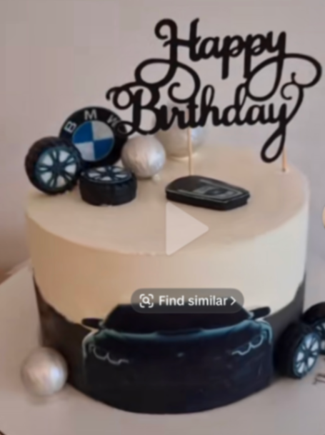 BMW themed birthday cake with black car printout, fondant tires, and a black Happy Birthday cardstock topper on beige icing.