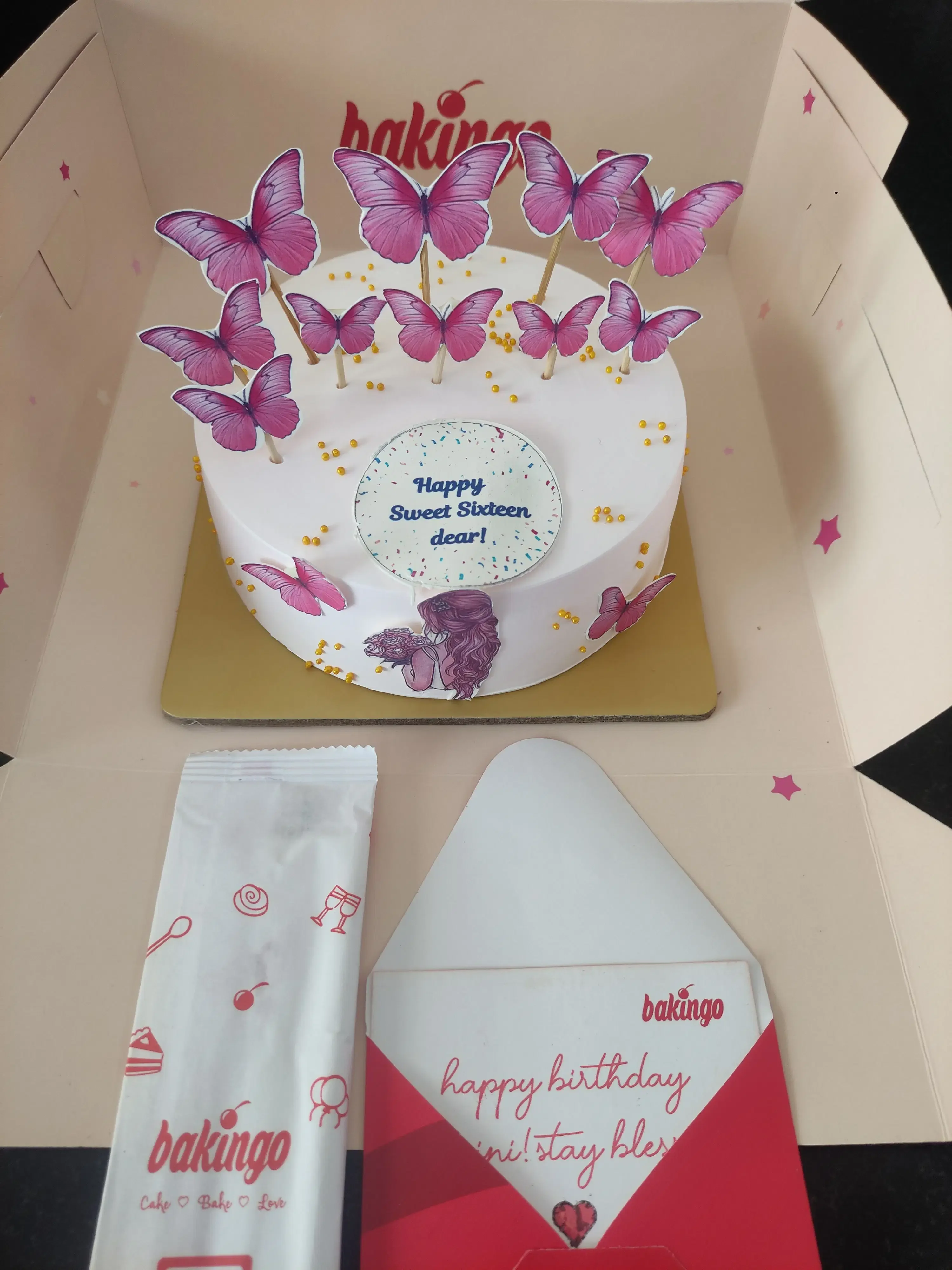 Butterfly Bento White Floral Cake White bento cake with pink butterfly printouts and a Happy Sweet Sixteen message