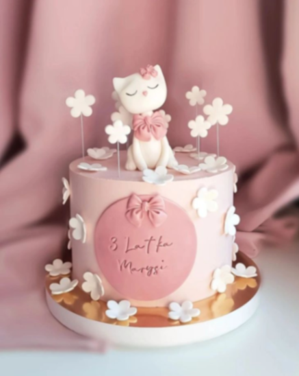Pink cat themed birthday cake with a 3D fondant cat topper, pink bow, and white gumpaste flowers. Pink cat themed birthday cake with a 3D fondant cat topper, pink bow, and white gumpaste flowers.