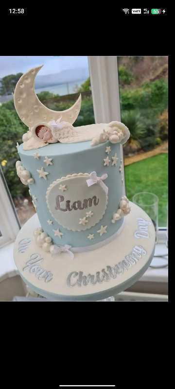 Christening Sky Blue Cake Sky blue 1-tier christening cake with smooth soft icing, a sleeping baby in a crescent moon topper, and fondant star accents
