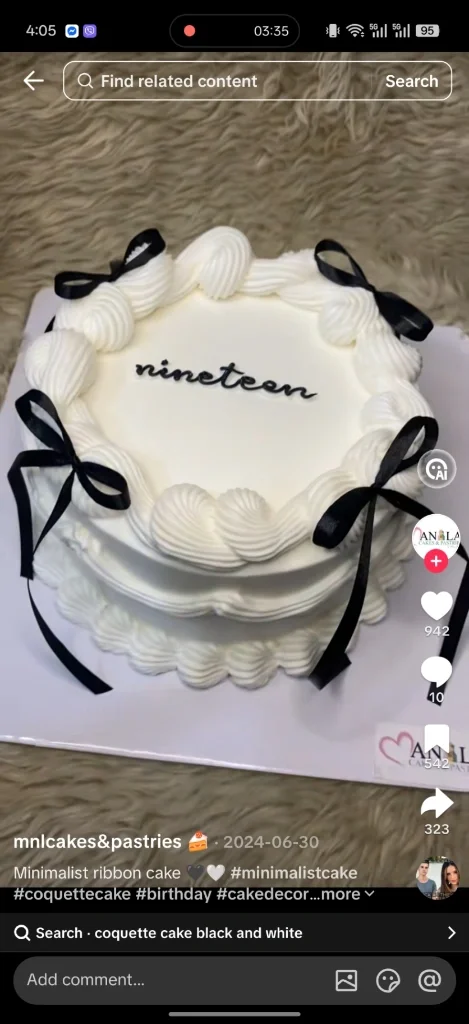 Minimalist white coquette cake with black satin ribbons and 'nineteen' piped in black icing. Minimalist white coquette cake with black satin ribbons and 'nineteen' piped in black icing.