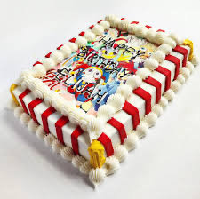 Rectangle birthday cake with colorful The Amazing Digital Circus character printout and red and white striped icing sides. Rectangle birthday cake with colorful The Amazing Digital Circus character printout and red and white striped icing sides.