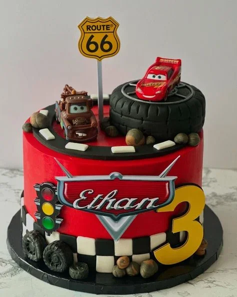 Red Disney Cars themed birthday cake for Ethan's 3rd birthday featuring Lightning McQueen and Mater on a tire and road track. Red Disney Cars themed birthday cake for Ethan's 3rd birthday featuring Lightning McQueen and Mater on a tire and road track.