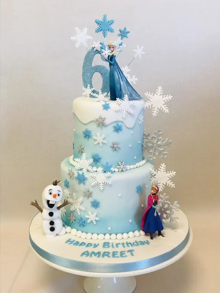 Frozen-Inspired Birthday White 2-Tier Cake Light blue 2-tier fondant cake with Frozen characters, glittery number six, and white snowflake decorations