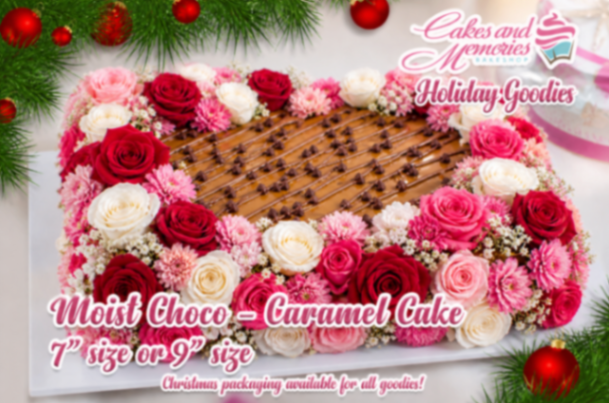 A white and brown Holiday Choco Caramel Rectangle cake with red and pink roses, chocolate chips, and drizzle.