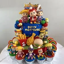 Jollitown themed blue fondant cake with Jollibee characters, chicken joy, and burger toppers surrounded by matching cupcakes.