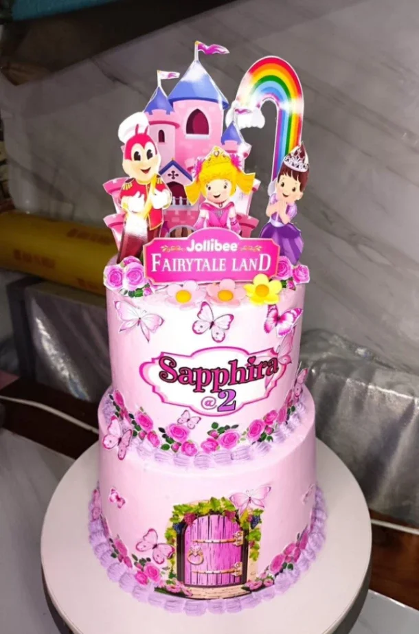 Pink 2-tier Jollibee Fairytale Land birthday cake with castle, rainbow, and character printouts for Sapphira's 2nd birthday. Pink 2-tier Jollibee Fairytale Land birthday cake with castle, rainbow, and character printouts for Sapphira's 2nd birthday.