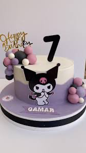 Purple and white Kuromi themed birthday cake with a large character cutout, number 7 topper, and fondant ball clusters. Purple and white Kuromi themed birthday cake with a large character cutout, number 7 topper, and fondant ball clusters.