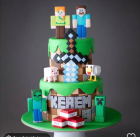 Two-tier Minecraft themed fondant cake with edible 3D characters including Steve, Alex, a Creeper, and a Zombie with a pixelated sword. Two-tier Minecraft themed fondant cake with edible 3D characters including Steve, Alex, a Creeper, and a Zombie with a pixelated sword.