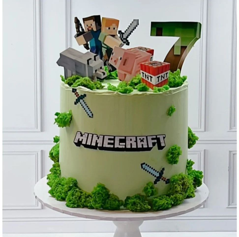 Minecraft themed birthday cake with Steve, Alex, and pixelated animals on light green icing with mossy green accents. Minecraft themed birthday cake with Steve, Alex, and pixelated animals on light green icing with mossy green accents.